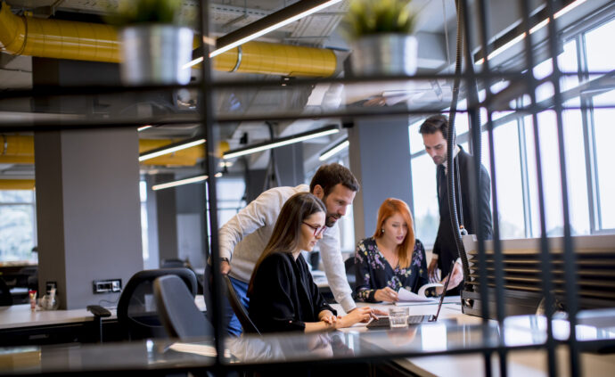 Group of young business people are working together with desktop
